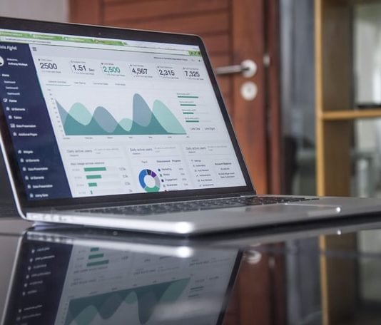 A laptop with charts signifying starting a business in Canada as an expat