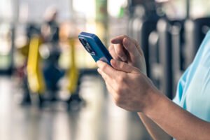 woman using smartphone fitness gym close up